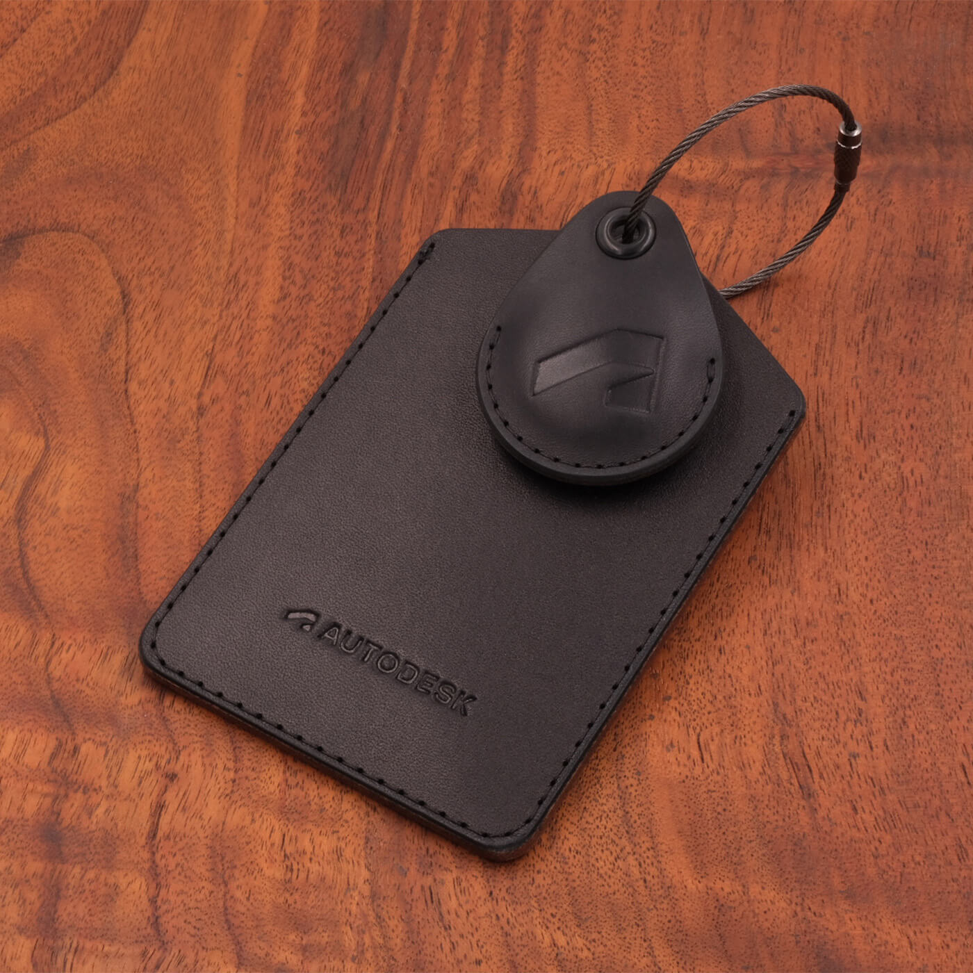 Black leather Executive Luggage Tag with black leather AirTag holder, black luggage loop, and Autodesk logo