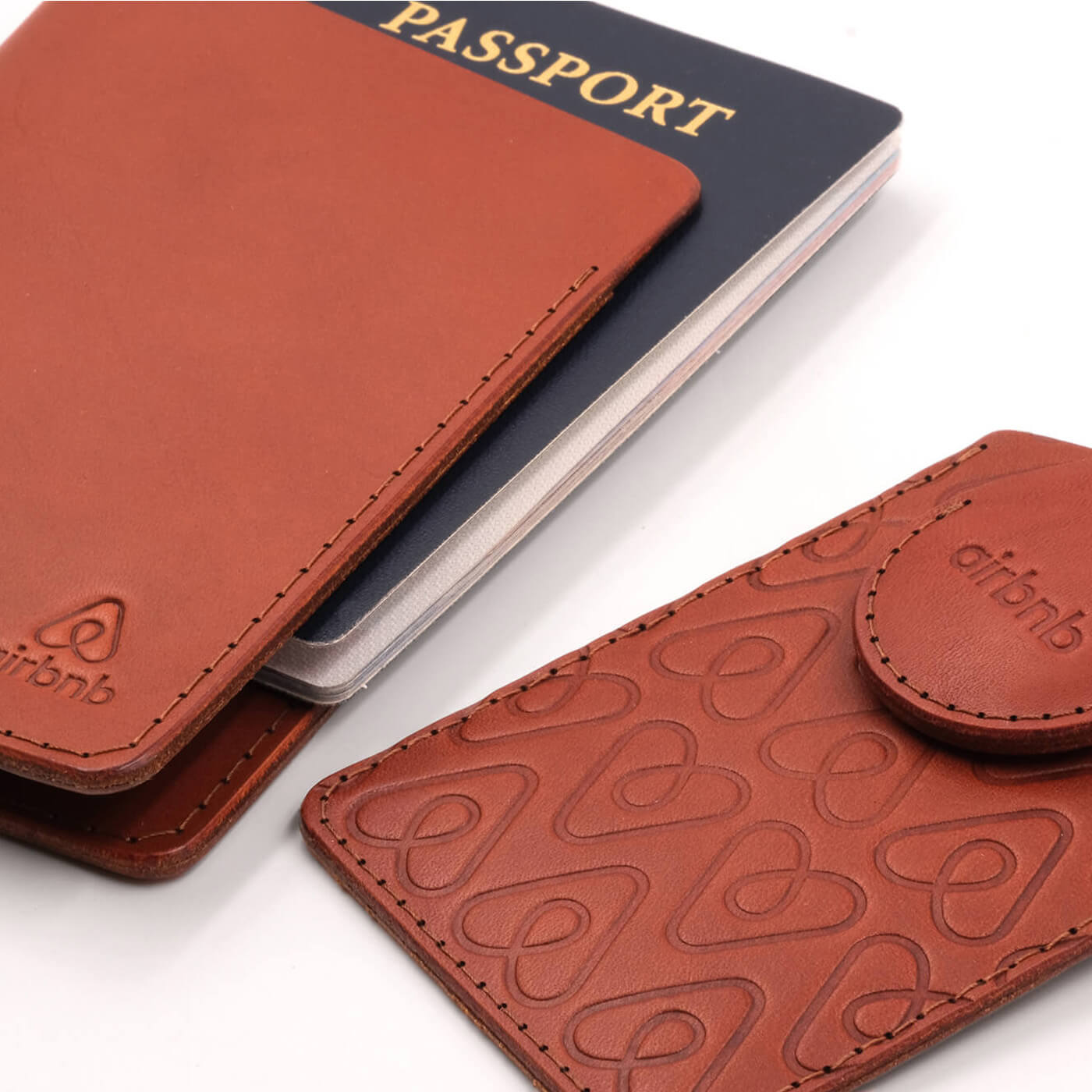 Brown leather Passport Holder, Executive Luggage Tag with brown leather AirTag holder, brass luggage loop, and Airbnb logo
