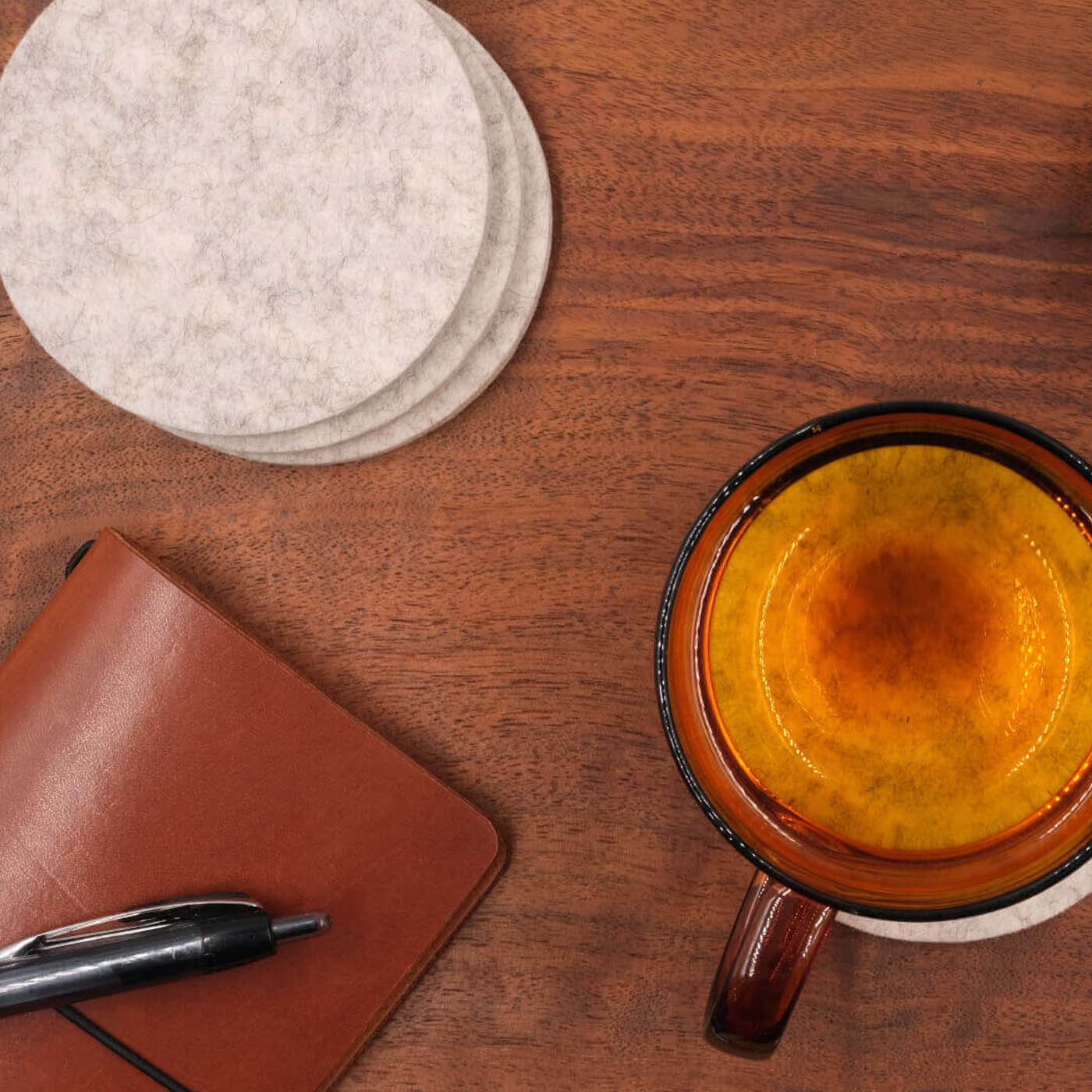 Light gray Woolsters on a table with the Pocket Journal in brown leather