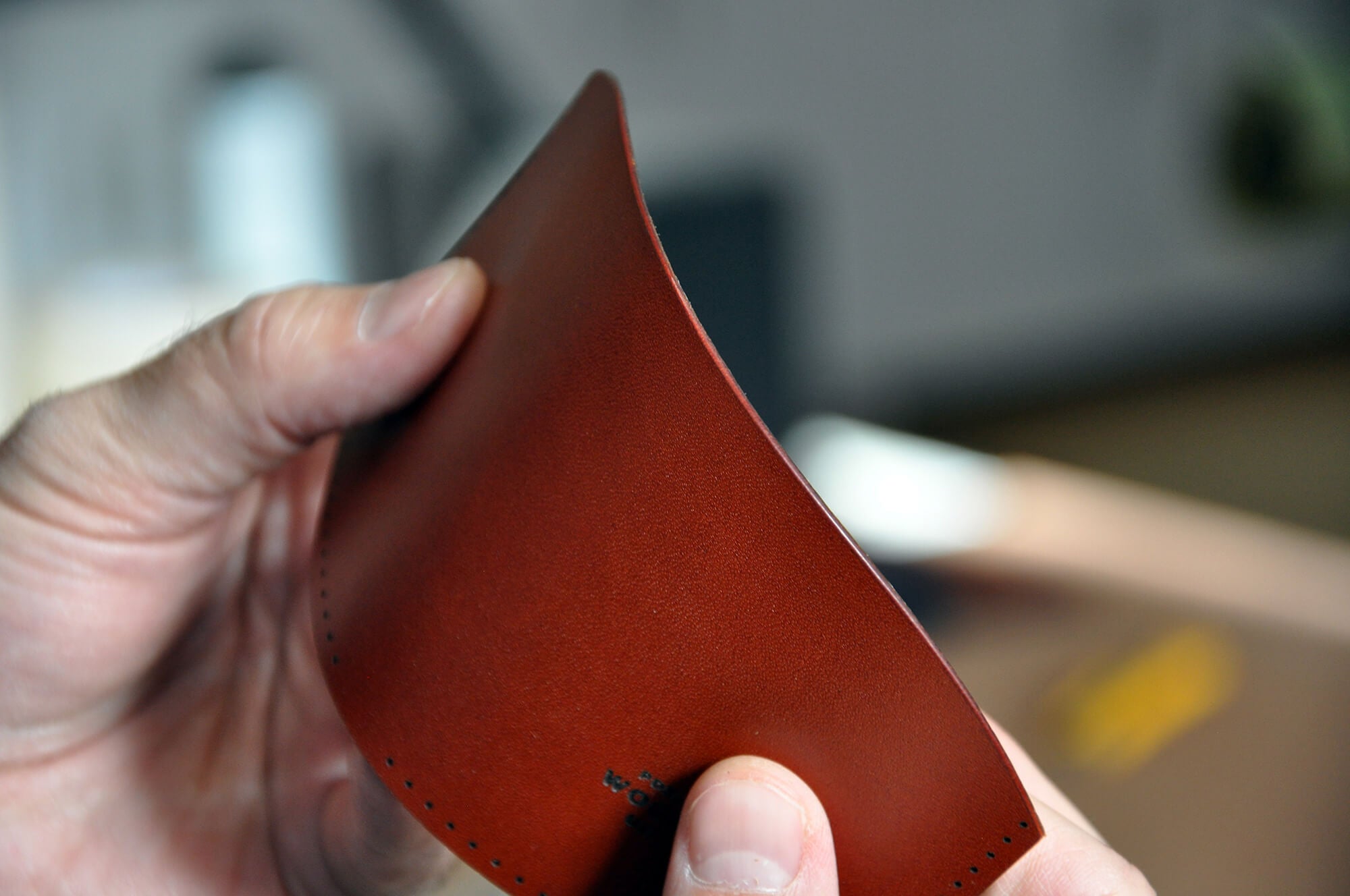 Hands folding a piece of leather for a Half Wallet.