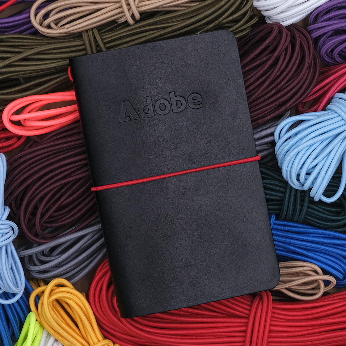 Pocket Journal in black leather, and red elastic cord.