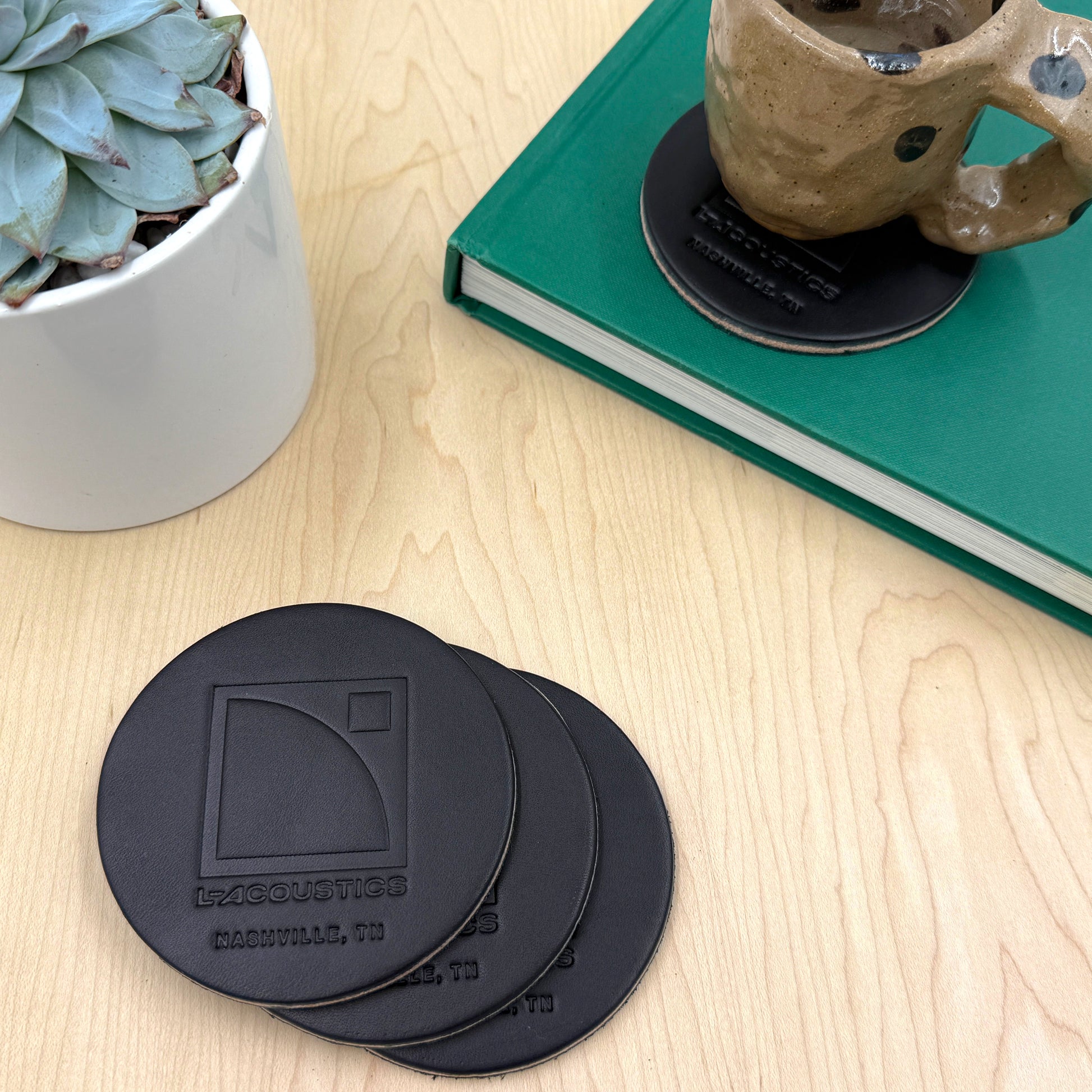 Woolly Made customized black leather debossed coasters.