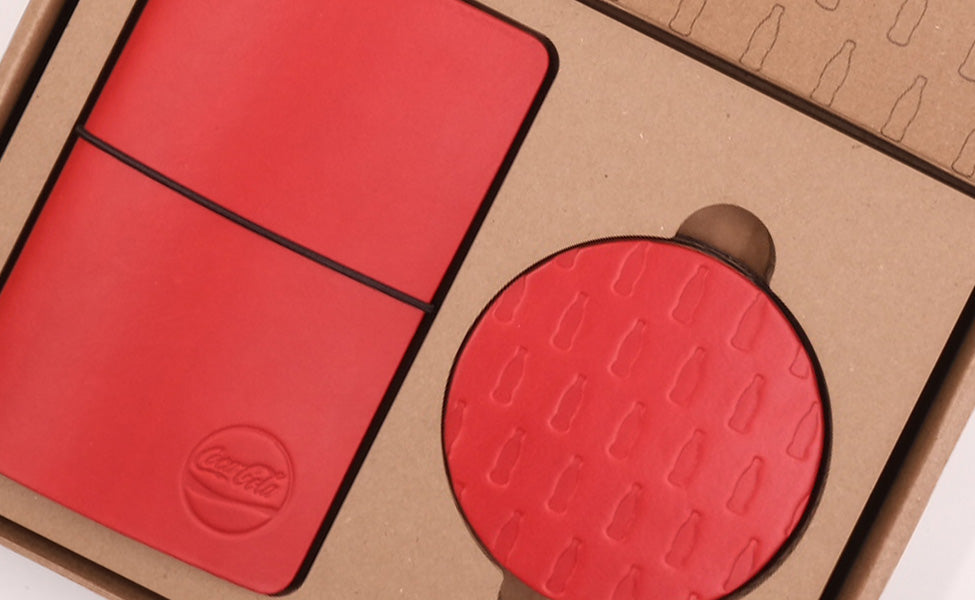 Coca-Cola branded Pocket Journal and Round Coasters in red and black leather plus custom packaging.