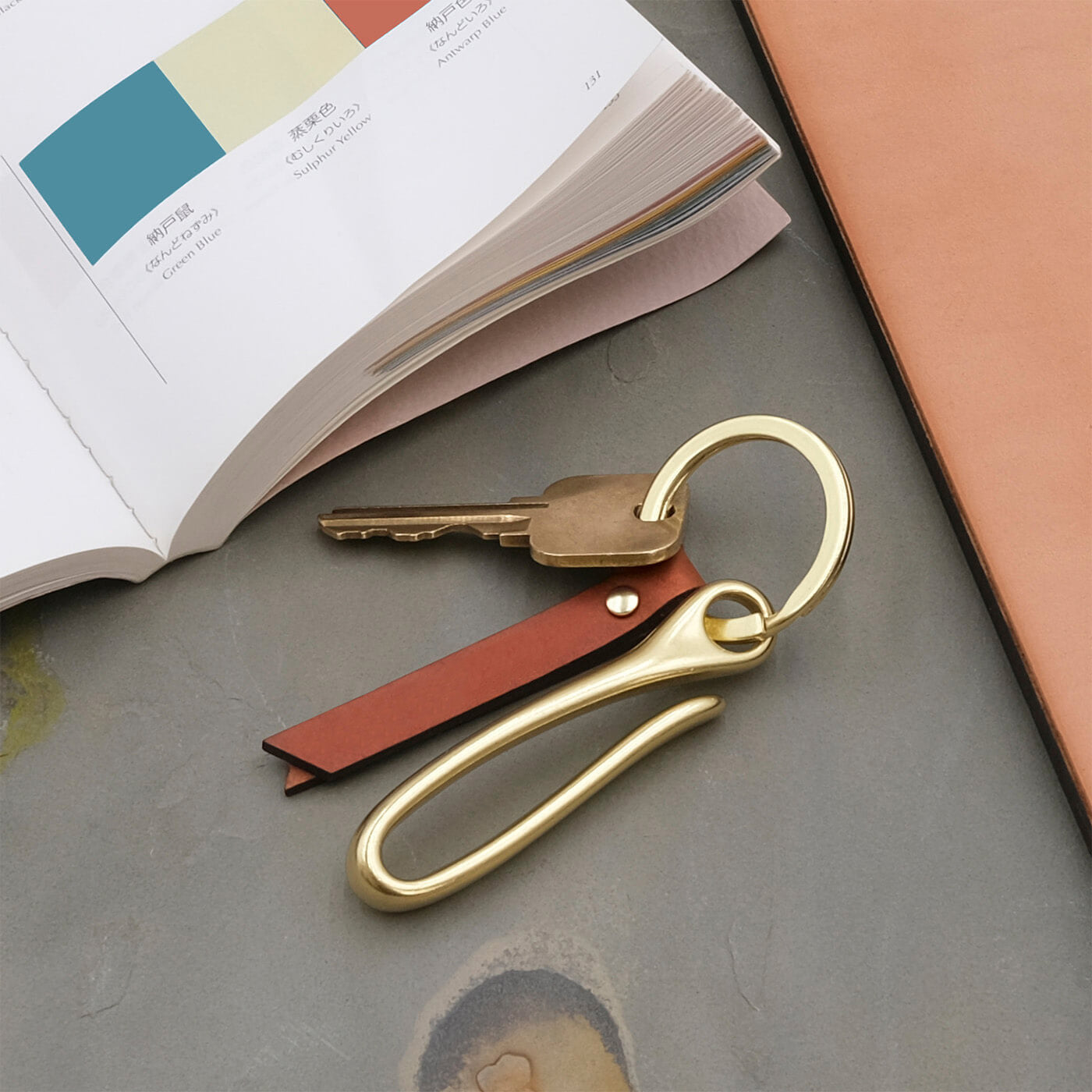 Fish Hook Keychain in brown leather in a lifestyle scene.