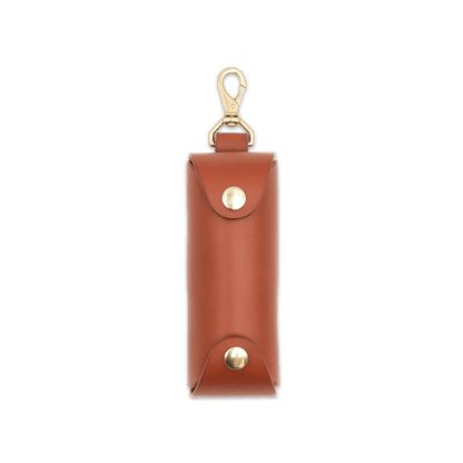 Woolly Made brown leather Golf Ball Sleeve with brass hardware.
