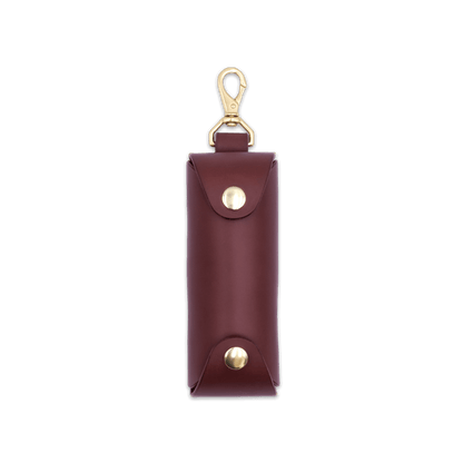 Woolly Made burgundy leather Golf Ball Sleeve with brass hardware.