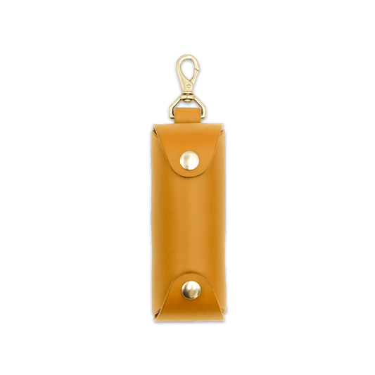 Woolly Made gold leather Golf Ball Sleeve with brass hardware.