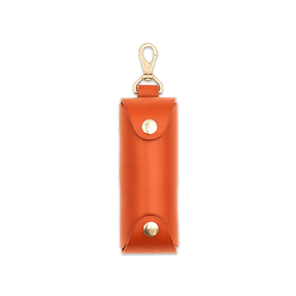 Woolly Made orange leather Golf Ball Sleeve with brass hardware.
