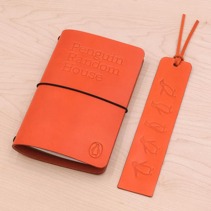 Home & Office Kit Pocket Journal and Tassle Bookmark on a wooden table.