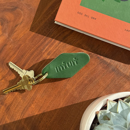 Leather hotel keychain made from green leather with Intuit logo debossed, custom promotional corporate gift.