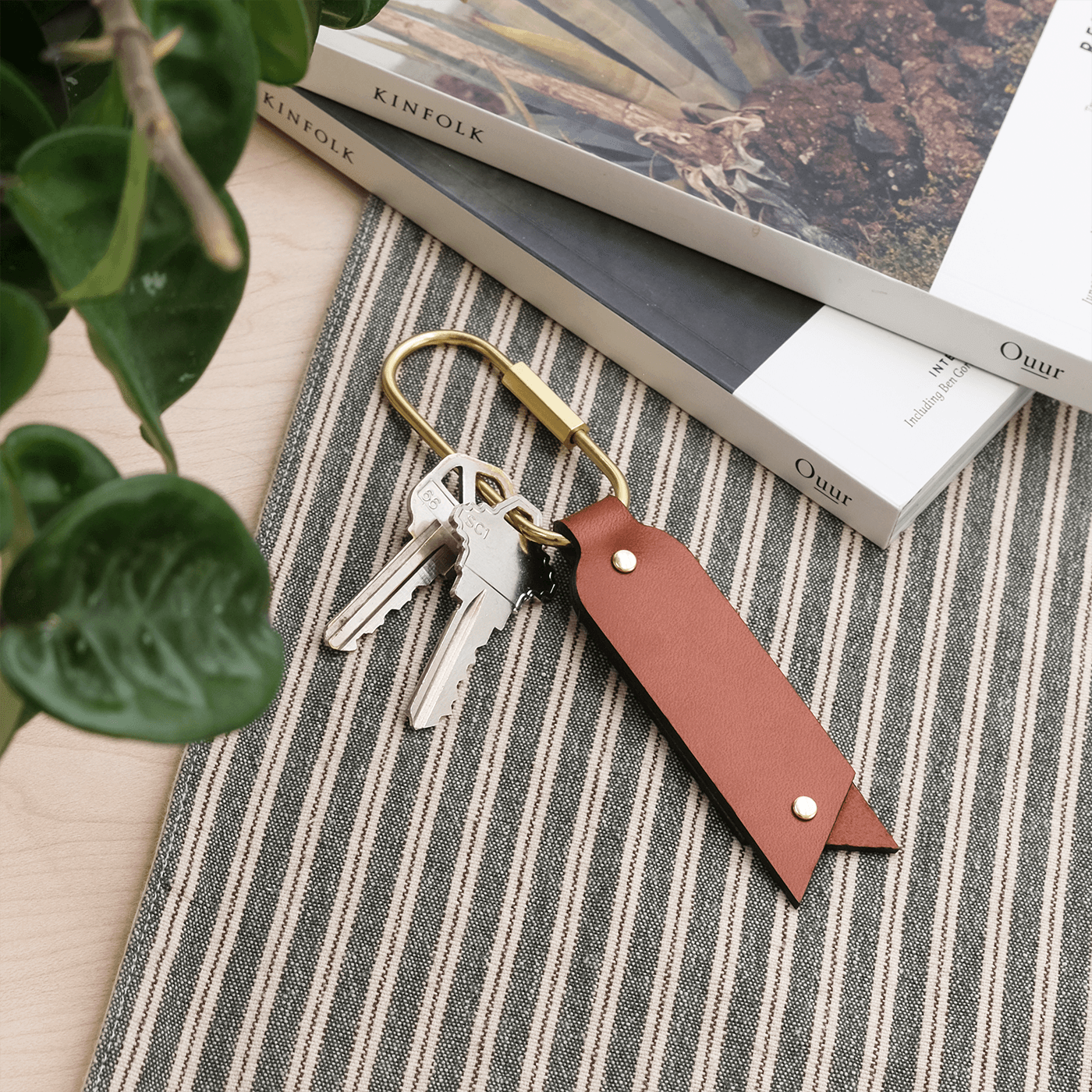 Oval Keychain in brown leather in a  lifestyle scene.