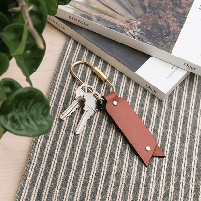 Oval Keychain in brown leather in a  lifestyle scene.