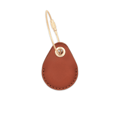 Brown leather AirTag holder with brass luggage loop