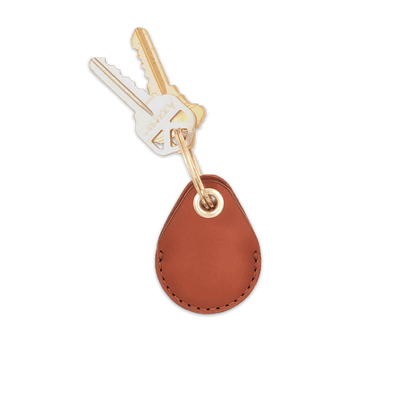 Brown leather AirTag holder with brass keychain and keys