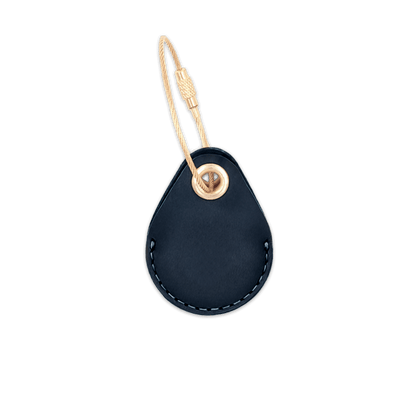 Navy leather AirTag holder with brass luggage loop