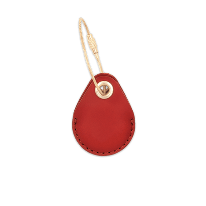 Red leather AirTag holder with brass luggage loop