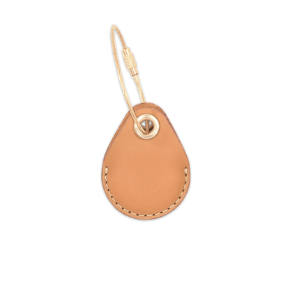 Tan leather AirTag holder with brass luggage loop