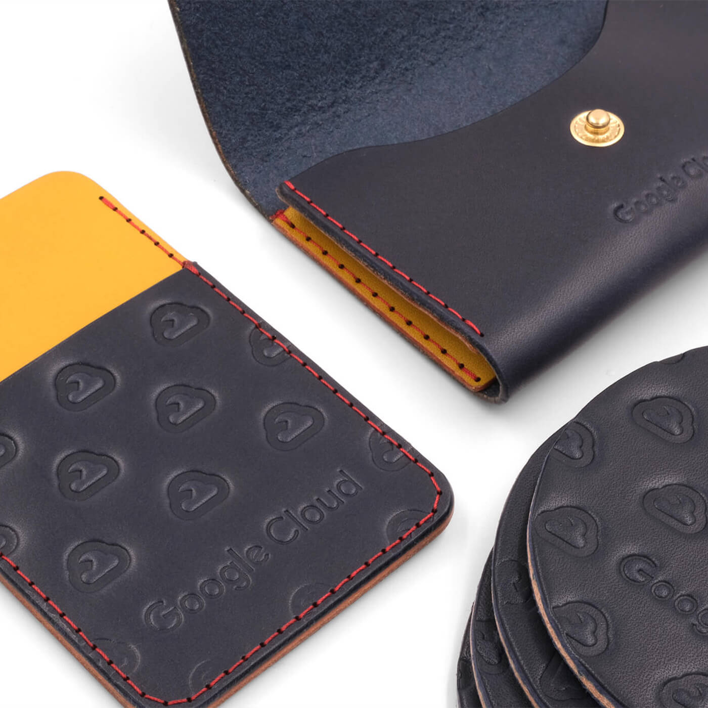 Navy, red, and yellow leather Business Card Holder, Coasters, and ID Badge Holder with Google Cloud logo.