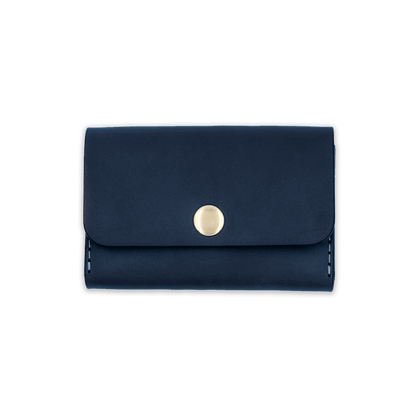 Navy leather with stitching, a fold, and brass snap closure.