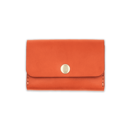 Orange leather with stitching, a fold, and brass snap closure.