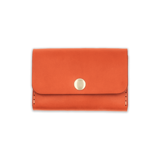 Orange leather with stitching, a fold, and brass snap closure.