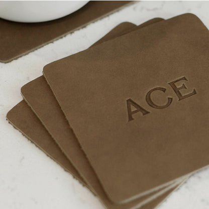 Olive square leather coasters stack with ACE logo.