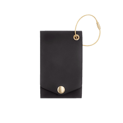 Black leather luggage tag with fold closure and brass hardware.