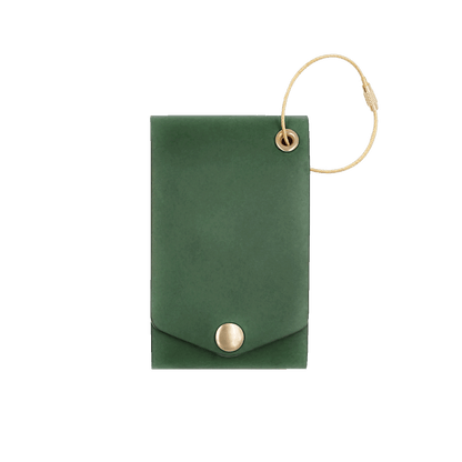 Green leather luggage tag with fold closure and brass hardware.