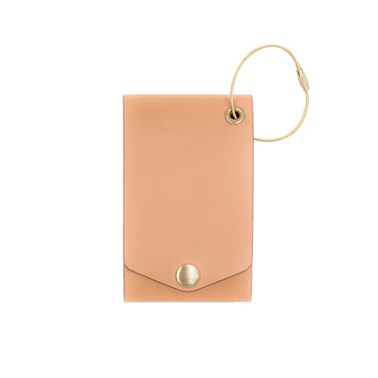 Natural leather luggage tag with fold closure and brass hardware.