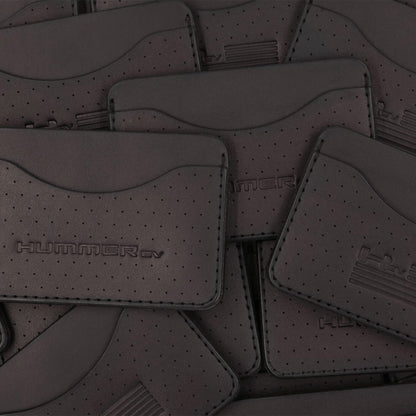 Pile of black leather Slim Wallets with decorative perforation and Hummer logos.