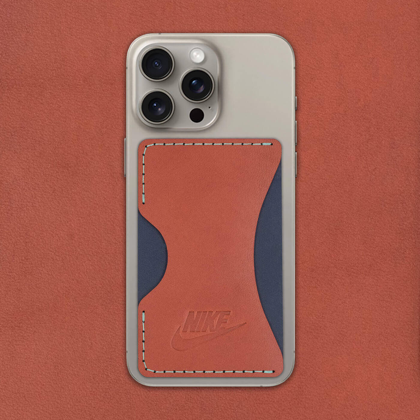 Brown and navy leather Stick-On Wallet with Nike logo on iPhone.