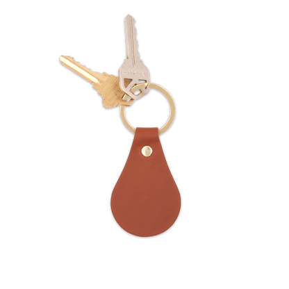 Brown leather  teardrop-shaped keychain with brass hardware and keys.