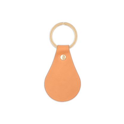 Tan leather teardrop-shaped keychain with brass hardware.