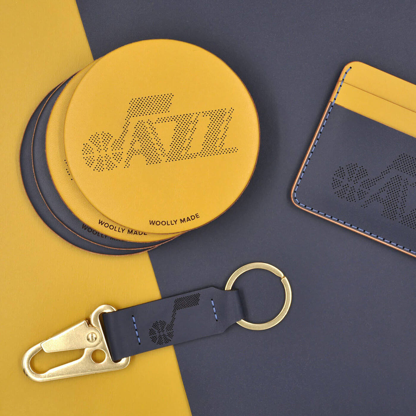 Yellow and navy coasters, half wallet, and clip keychain with gold hardware and Utah Jazz logos