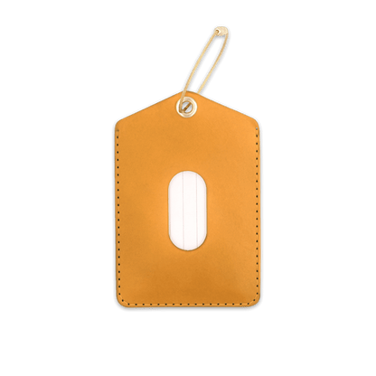 Gold leather luggage tag with brass hardware and card window