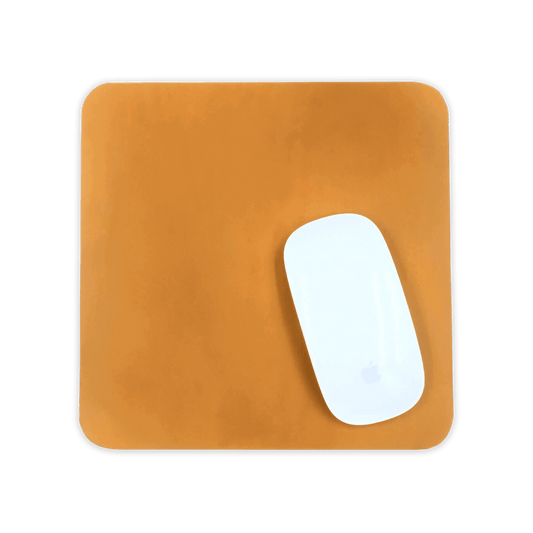 White computer mouse on a gold leather mouse pad 