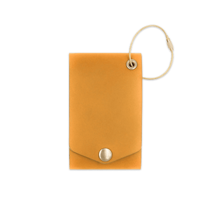 Gold leather luggage tag with brass hardware and snap closure 