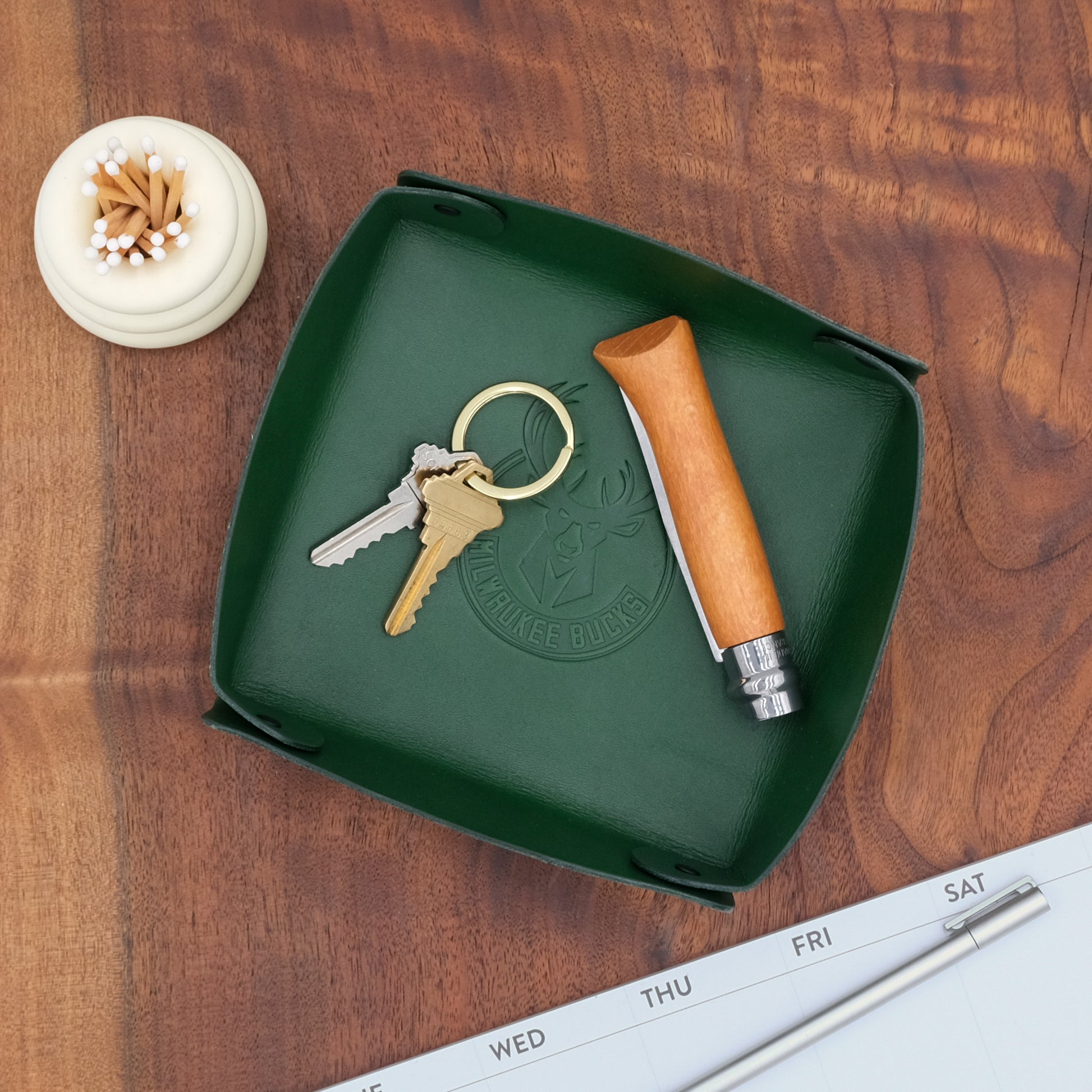 Green leather valet tray with debossed Milwaukee Bucks logo, ideal for promotional gifting.