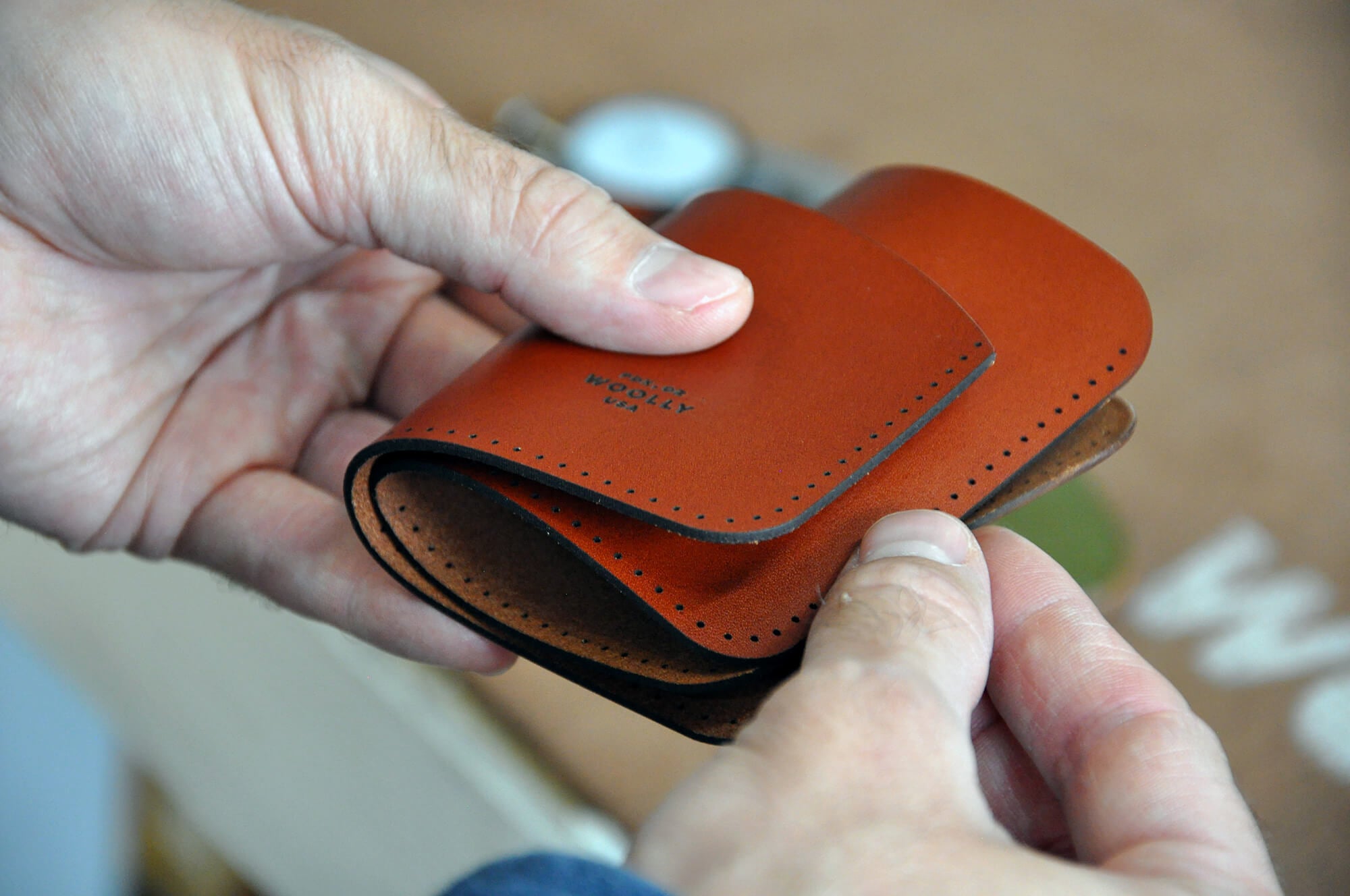 Hands assembling a Half Wallet.